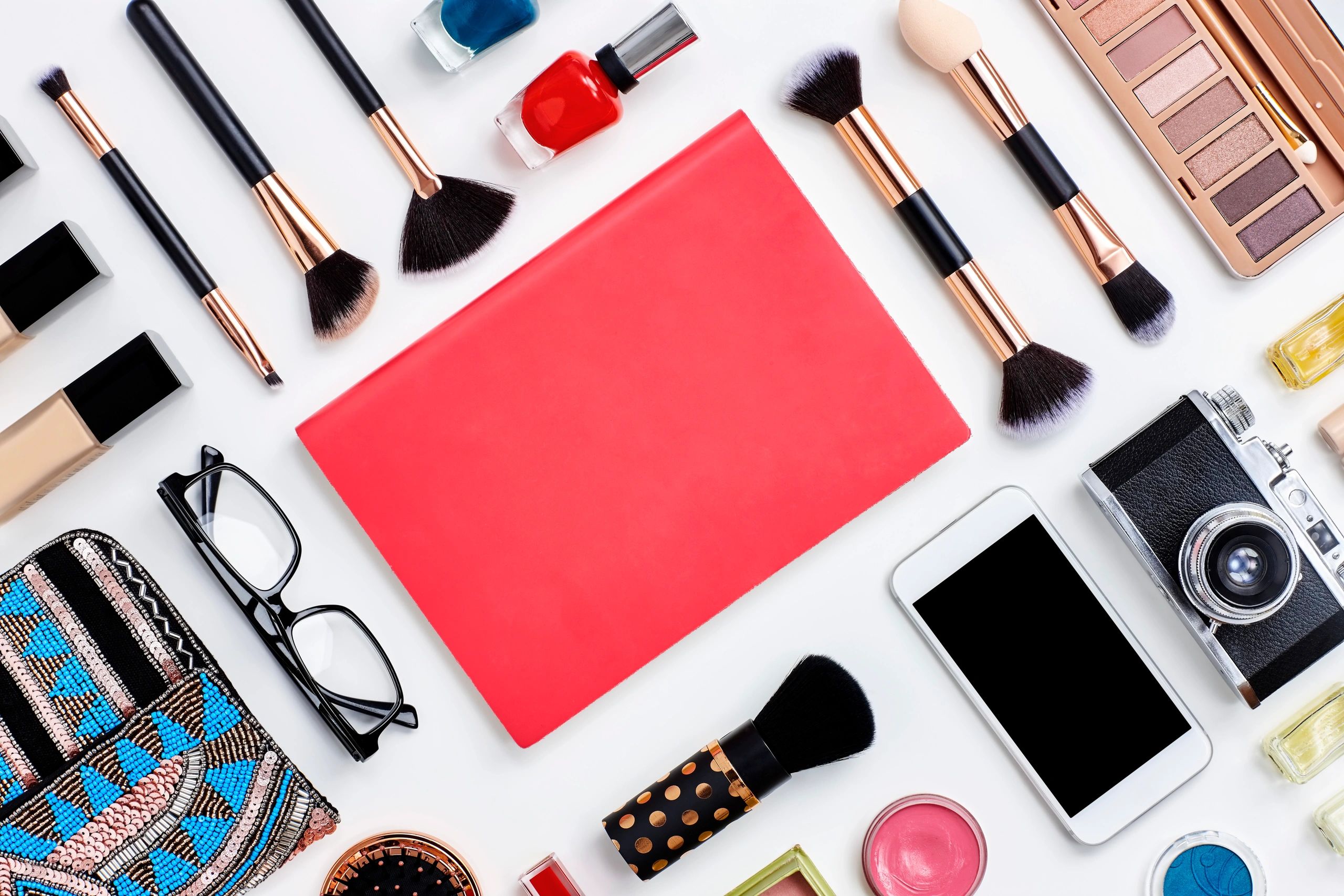 Beauty products flat lay with soft pink styling